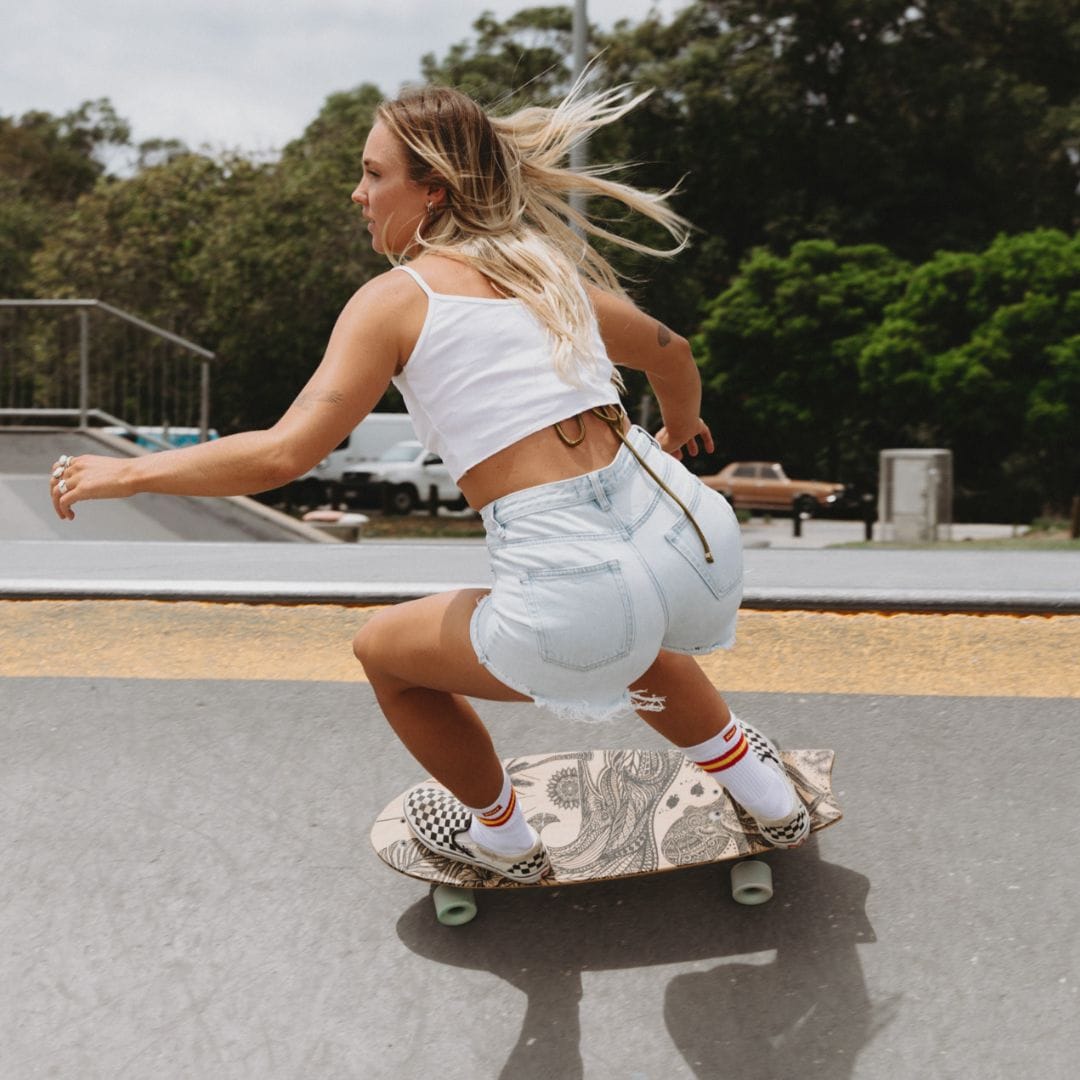 A rider carving a skateboard in a concrete skate park.