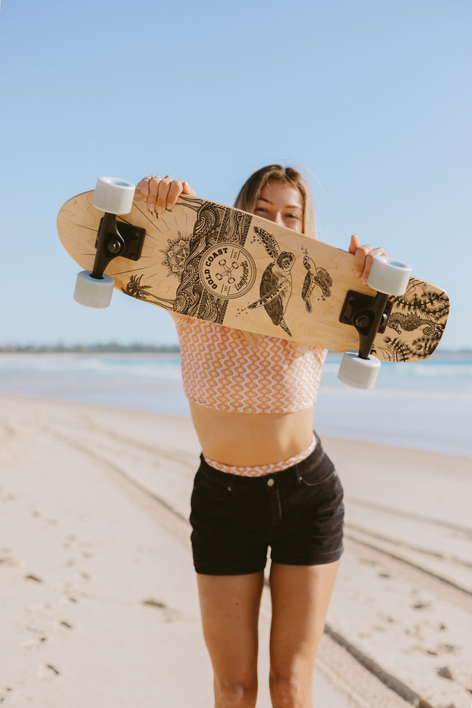 Girl holding mandala art cruiser skateboard